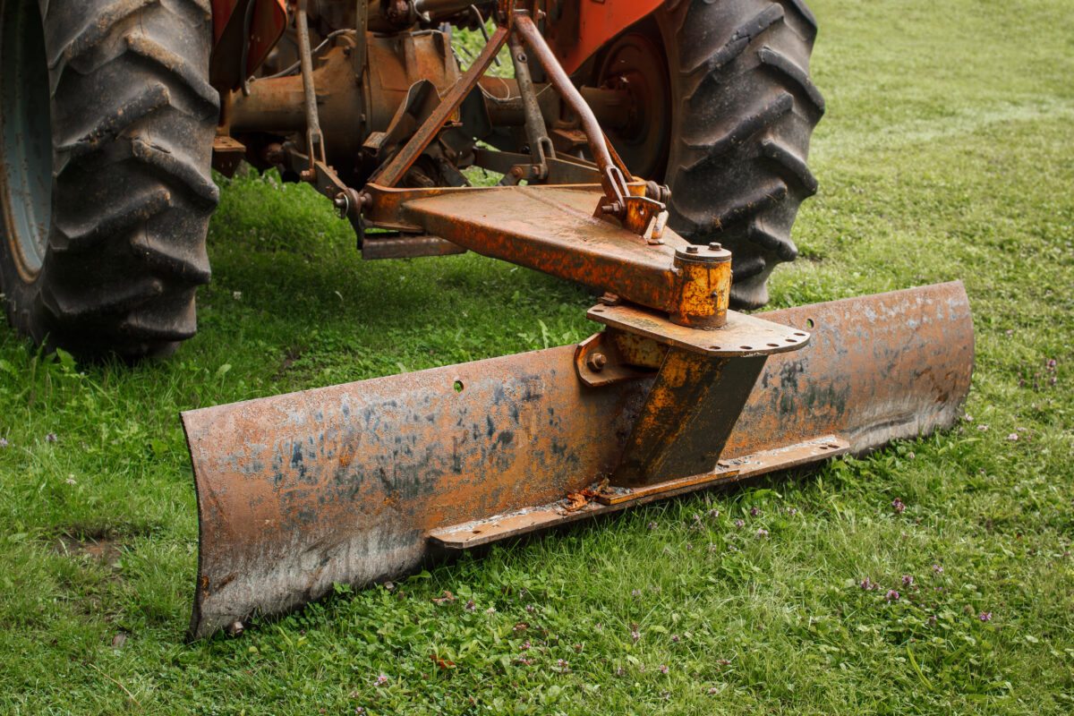 farm tractor levelling blade attached to a three point hitch
