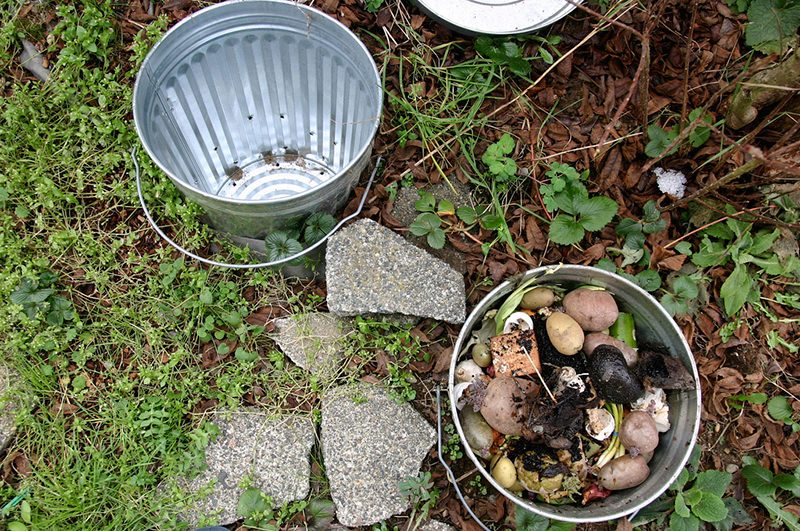 A half-buried trashcan with holes drilled into it is a simple compost method.