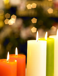 Red, white and green pillar candles against a holiday backdrop