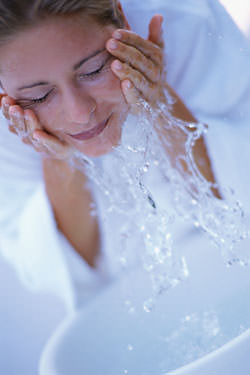 woman washing face woman washing face