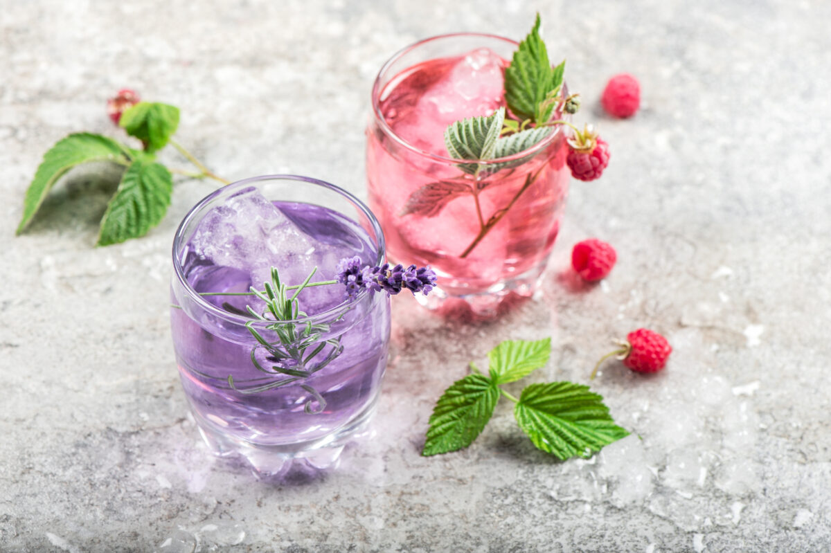 floral infused water drink with raspberries, lavender flowers and ice