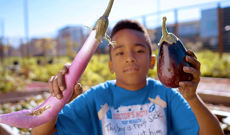 child eating eggplants